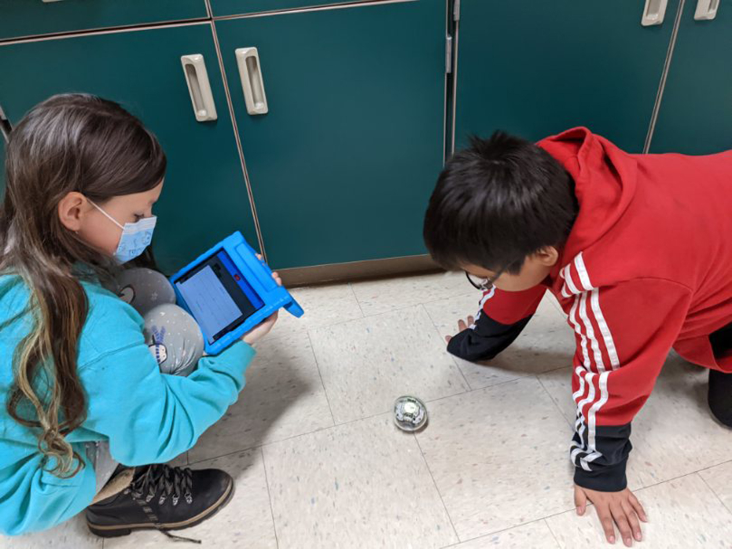 picture of students with robot